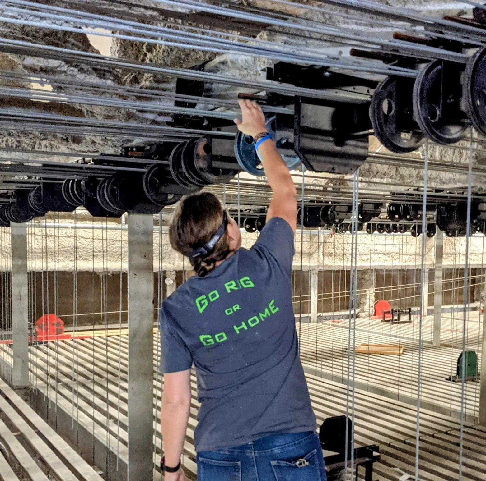 Rigger working on a counterweight rigging system